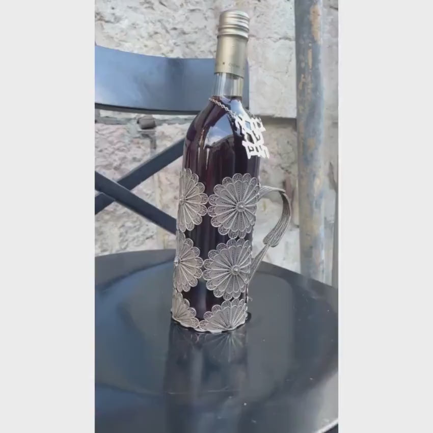 Load video: Silver Bottle Holder with Filigree Work